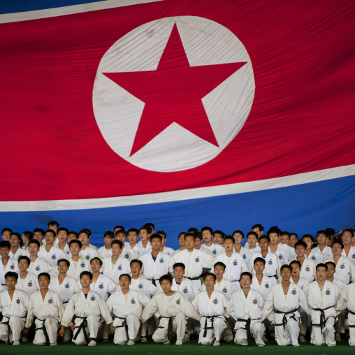 North Korean taekwondo team in front of a giant flag during the Arirang mass games in may day stadium, Pyongan Province, Pyongyang, North Korea
