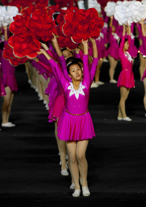 North Korean gymnasts holiding red flowers during Arirang mass games in may day stadium, Pyongan Province, Pyongyang, North Korea