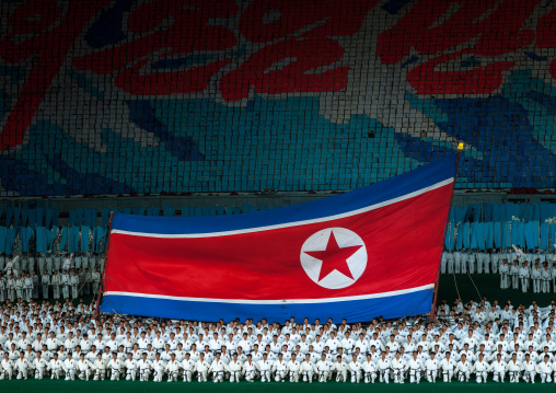North Korean taekwondo team in front of a giant flag during the Arirang mass games in may day stadium, Pyongan Province, Pyongyang, North Korea