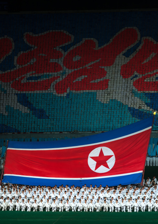 North Korean taekwondo team in front of a giant flag during the Arirang mass games in may day stadium, Pyongan Province, Pyongyang, North Korea
