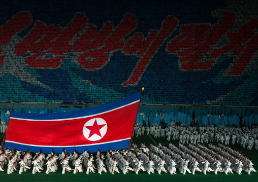 North Korean taekwondo team in front of a giant flag during the Arirang mass games in may day stadium, Pyongan Province, Pyongyang, North Korea