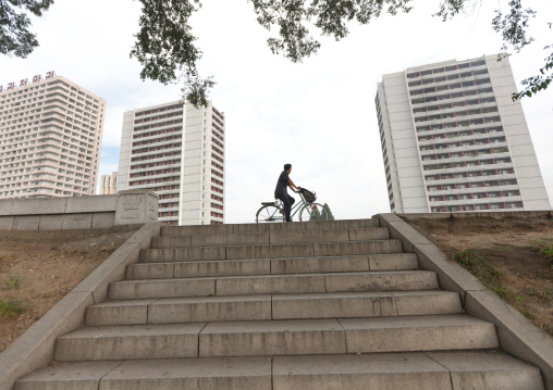 North Korean man riding a bicycle in the city, Pyongan Province, Pyongyang, North Korea