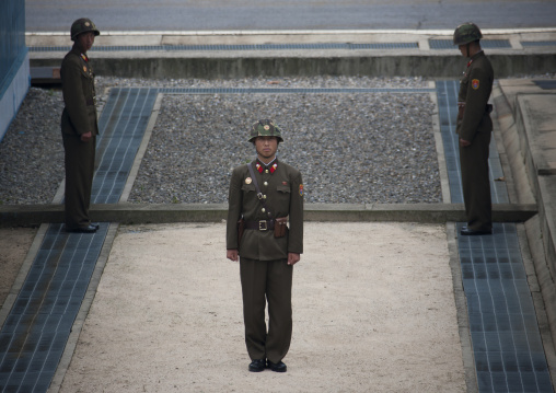 North Korean soldiers standing in front of the United Nations conference rooms on the demarcation line in the Demilitarized Zone, North Hwanghae Province, Panmunjom, North Korea