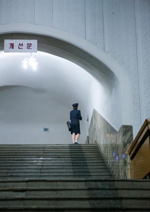 North Korean woman employee at top of stairs in a subway station, Pyongan Province, Pyongyang, North Korea