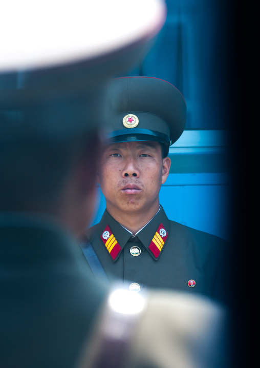 North Korean soldiers standing in front of the United Nations conference rooms on the demarcation line in the Demilitarized Zone, North Hwanghae Province, Panmunjom, North Korea