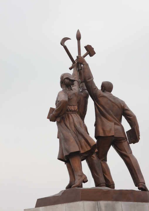 Statues at the bottom of the Juche tower built to commemorate Kim il-sung's 70th birthday, Pyongan Province, Pyongyang, North Korea