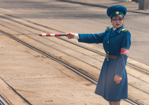 North Korean traffic security officer in blue uniform in the street, Pyongan Province, Pyongyang, North Korea