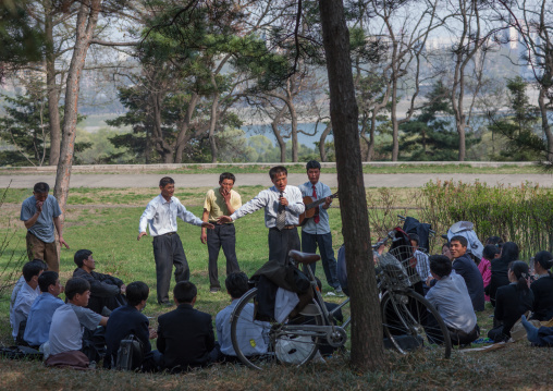 North Korean people celebrating april 15 the birth anniversary of Kim Il-sung in a park, Pyongan Province, Pyongyang, North Korea