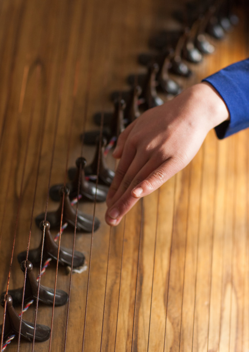 North Korean girl playing kayagum in Mangyongdae schoolchildren's palace, Pyongan Province, Pyongyang, North Korea