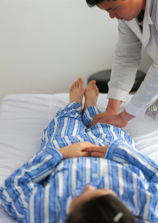 North Korean doctor making a massage to a patient, Pyongan Province, Pyongyang, North Korea