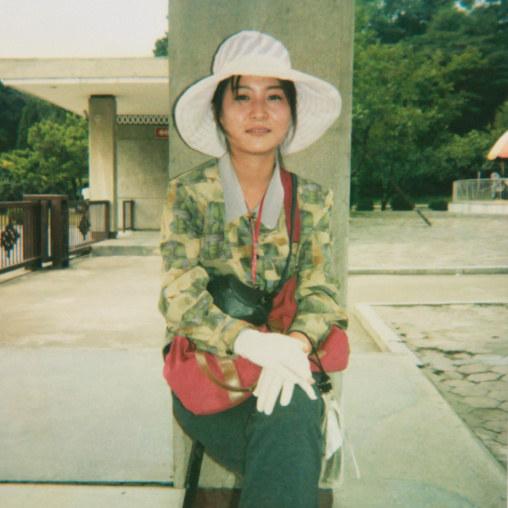 Polaroid of a smiling North Korean woman with a hat, Pyongan Province, Pyongyang, North Korea