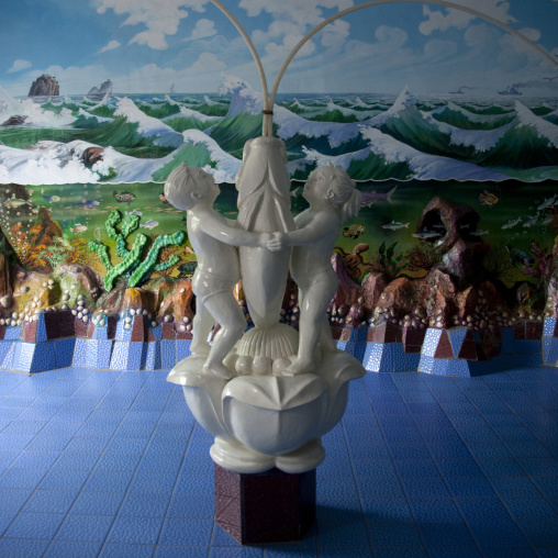 Naive statue of children and fish in the empty pool of a school, South Pyongan Province, Chongsan-ri Cooperative Farm, North Korea