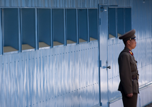 North Korean soldier standing in front of the United Nations conference rooms on the demarcation line in the Demilitarized Zone, North Hwanghae Province, Panmunjom, North Korea