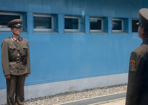 North Korean soldiers standing in front of the United Nations conference rooms on the demarcation line in the Demilitarized Zone, North Hwanghae Province, Panmunjom, North Korea