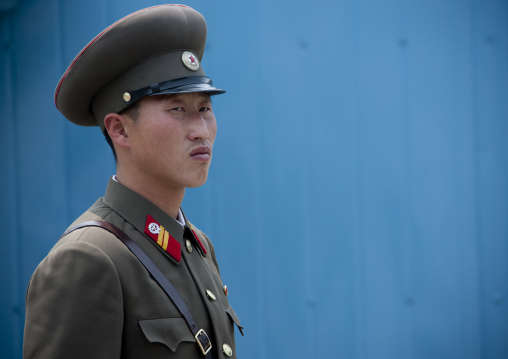North Korean soldier standing in front of the United Nations conference rooms on the demarcation line in the Demilitarized Zone, North Hwanghae Province, Panmunjom, North Korea