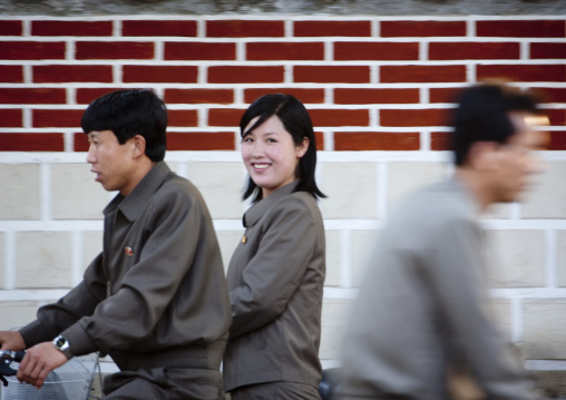 North Korean couple riding a bicycle in town, North Hwanghae Province, Kaesong, North Korea