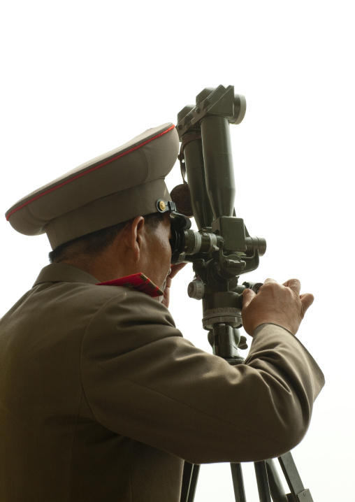 North Korean soldier looking south Korea with binoculars at the Demilitarized Zone, North Hwanghae Province, Panmunjom, North Korea