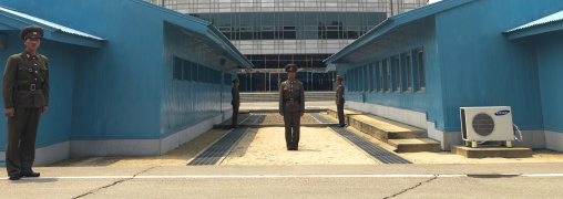 North Korean soldiers standing in front of the United Nations conference rooms on the demarcation line in the Demilitarized Zone, North Hwanghae Province, Panmunjom, North Korea
