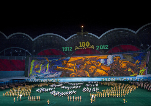 North Korean dancers in front of a war fresco during the Arirang mass games at may day stadium, Pyongan Province, Pyongyang, North Korea
