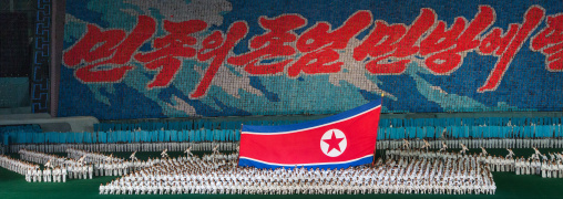 North Korean taekwondo team in front of a giant flag during the Arirang mass games in may day stadium, Pyongan Province, Pyongyang, North Korea