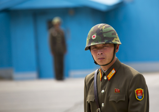 North Korean soldier wearing an helmet standing in front of the United Nations conference rooms on the demarcation line in the Demilitarized Zone, North Hwanghae Province, Panmunjom, North Ko