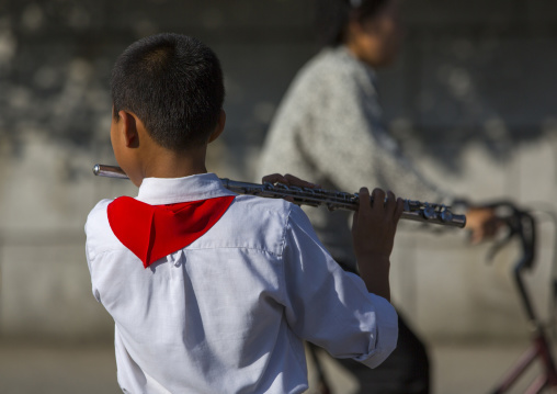 North Korean pioneer playing music in the street, Kangwon Province, Wonsan, North Korea