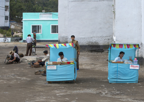 North Korean women selling food and drinks in little shops in the street, South Hamgyong Province, Hamhung, North Korea