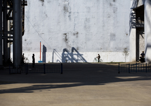 North Korean man riding a bicycle in Hungnam nitrogen fertilizer plant, South Hamgyong Province, Hamhung, North Korea