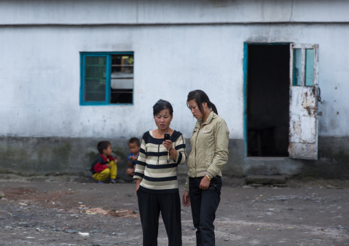 North Korean women with a mobile phone in the countryside, Pyongan Province, Pyongyang, North Korea