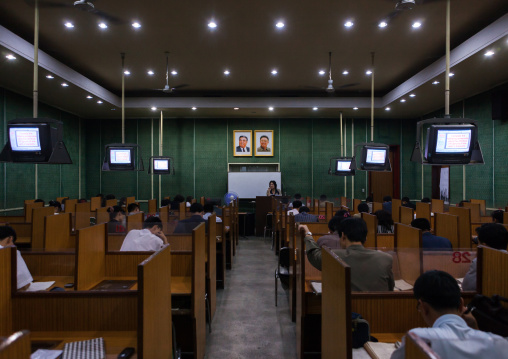 North Korean students during an english classroom in the Grand people's study house under the official portraits of the Dear Leaders, Pyongan Province, Pyongyang, North Korea