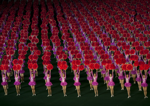 North Korean gymnasts holiding red flowers during Arirang mass games in may day stadium, Pyongan Province, Pyongyang, North Korea