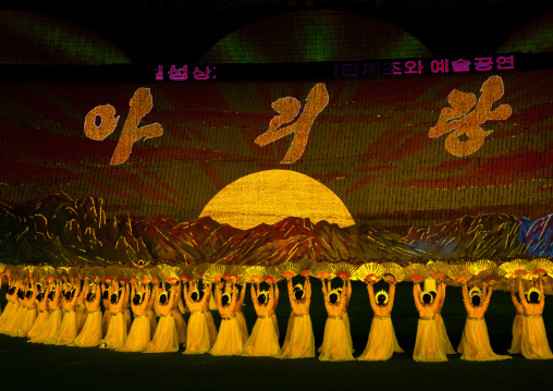 Rising sun over mount Paektu made by children pixels holding up colored boards during Arirang mass games in may day stadium, Pyongan Province, Pyongyang, North Korea