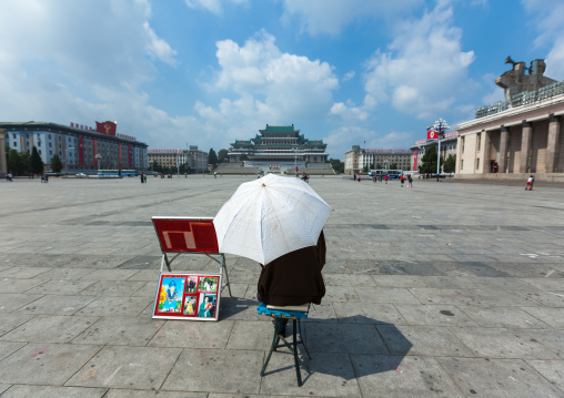 North Korean photographer waiting under an umbrella in Kim il Sung square, Pyongan Province, Pyongyang, North Korea