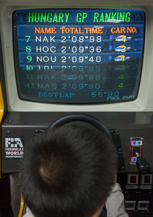 North Korean child on a car simulator in Kaeson youth park, Pyongan Province, Pyongyang, North Korea