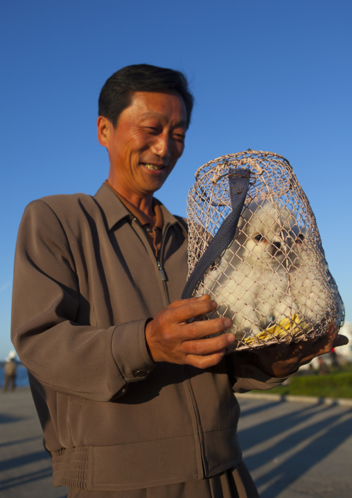 North Korean man buying dogs in a market, Kangwon Province, Wonsan, North Korea