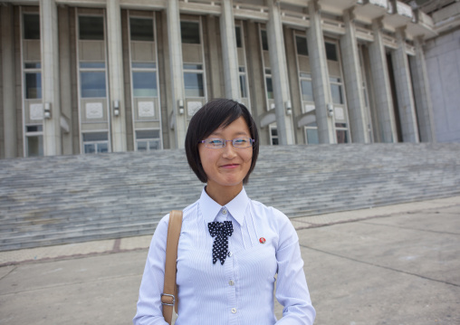 North Korean woman posing in front of the theatre entrance, South Hamgyong Province, Hamhung, North Korea