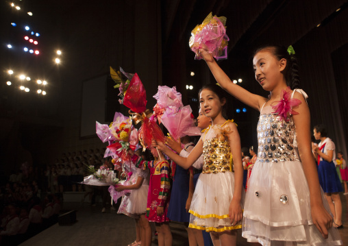 Young North Korean artists with flowers at the end of their show in Mangyongdae children's palace, Pyongan Province, Pyongyang, North Korea