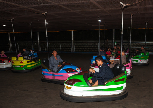 North Korean people having fun in bumper cars at Kaeson youth park, Pyongan Province, Pyongyang, North Korea
