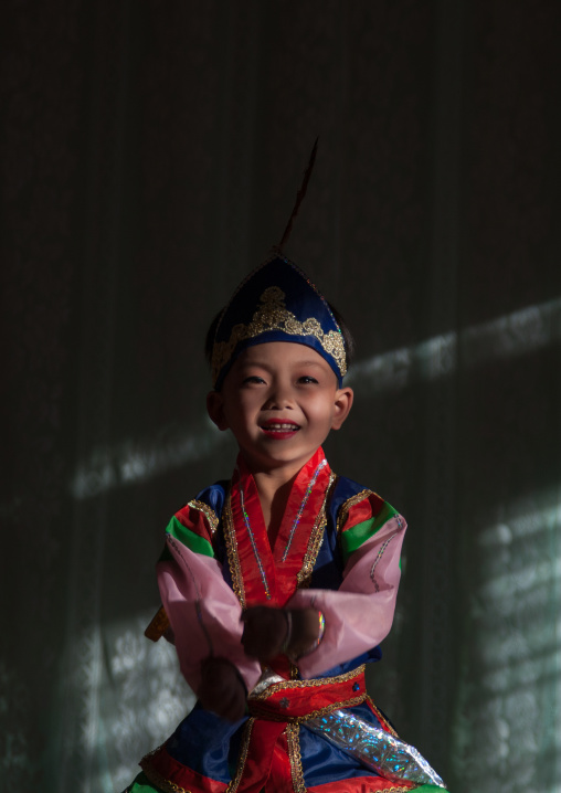 North Korean boy dancing in traditional clothing in Tchang Gwang school, North Hamgyong Province, Chongjin, North Korea