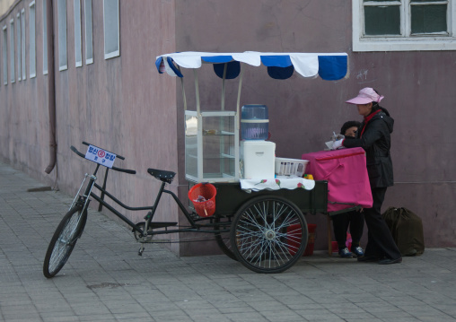 North Korean woman selling drinks in the street, Pyongan Province, Pyongyang, North Korea