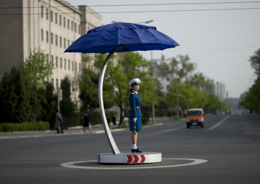 North Korean traffic security officer in blue uniform in the street, Pyongan Province, Pyongyang, North Korea