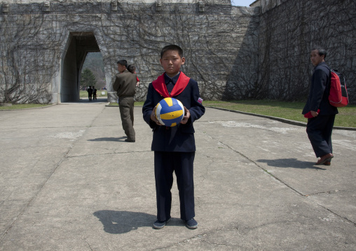 North Korean pioneer holding a ball in his hands, Pyongan Province, Pyongyang, North Korea