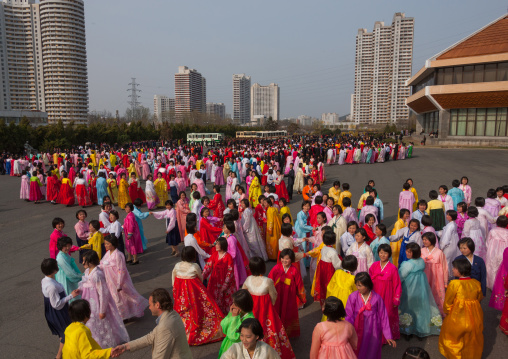 North Korean young adults during a mass dance performance in front of buildings on military foundation day, Pyongan Province, Pyongyang, North Korea