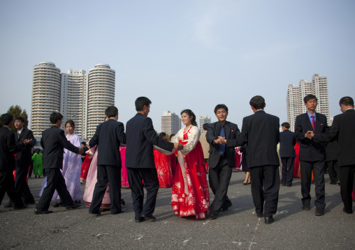 North Korean young adults during a mass dance performance in front of buildings on military foundation day, Pyongan Province, Pyongyang, North Korea