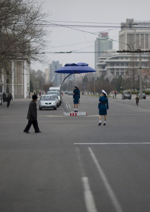 North Korean female traffic security officers in blue unforms in a busy street, Pyongan Province, Pyongyang, North Korea