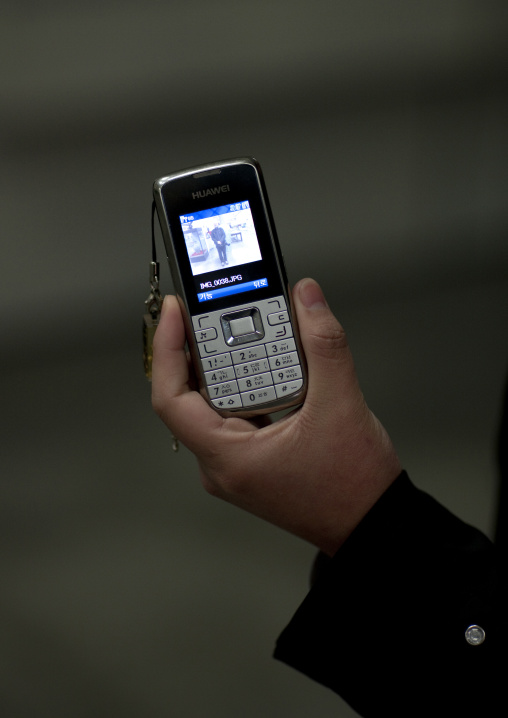 North Korean woman holding a huawei mobile phone, Pyongan Province, Pyongyang, North Korea