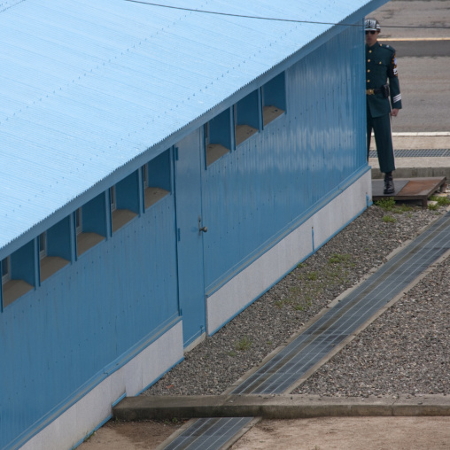 North Korean soldier standing in front of the United Nations conference rooms on the demarcation line in the Demilitarized Zone, North Hwanghae Province, Panmunjom, North Korea