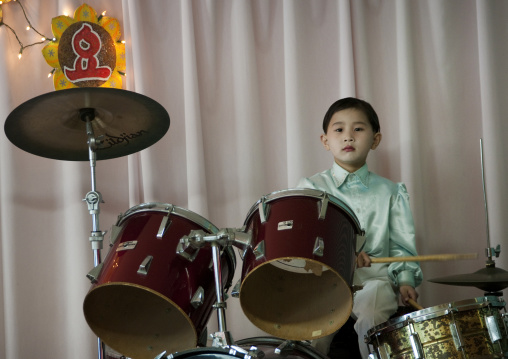Young North Korean boy playing drums in Kwangbok school, Pyongan Province, Pyongyang, North Korea