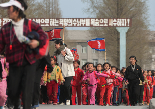 North Korean children parading in the streets on the international workers' day with the national flag, Kangwon Province, Wonsan, North Korea