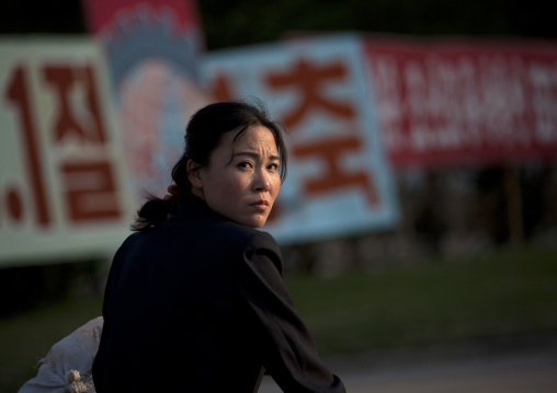 Portrait of a North Korean woman riding a bicycle, Kangwon Province, Wonsan, North Korea